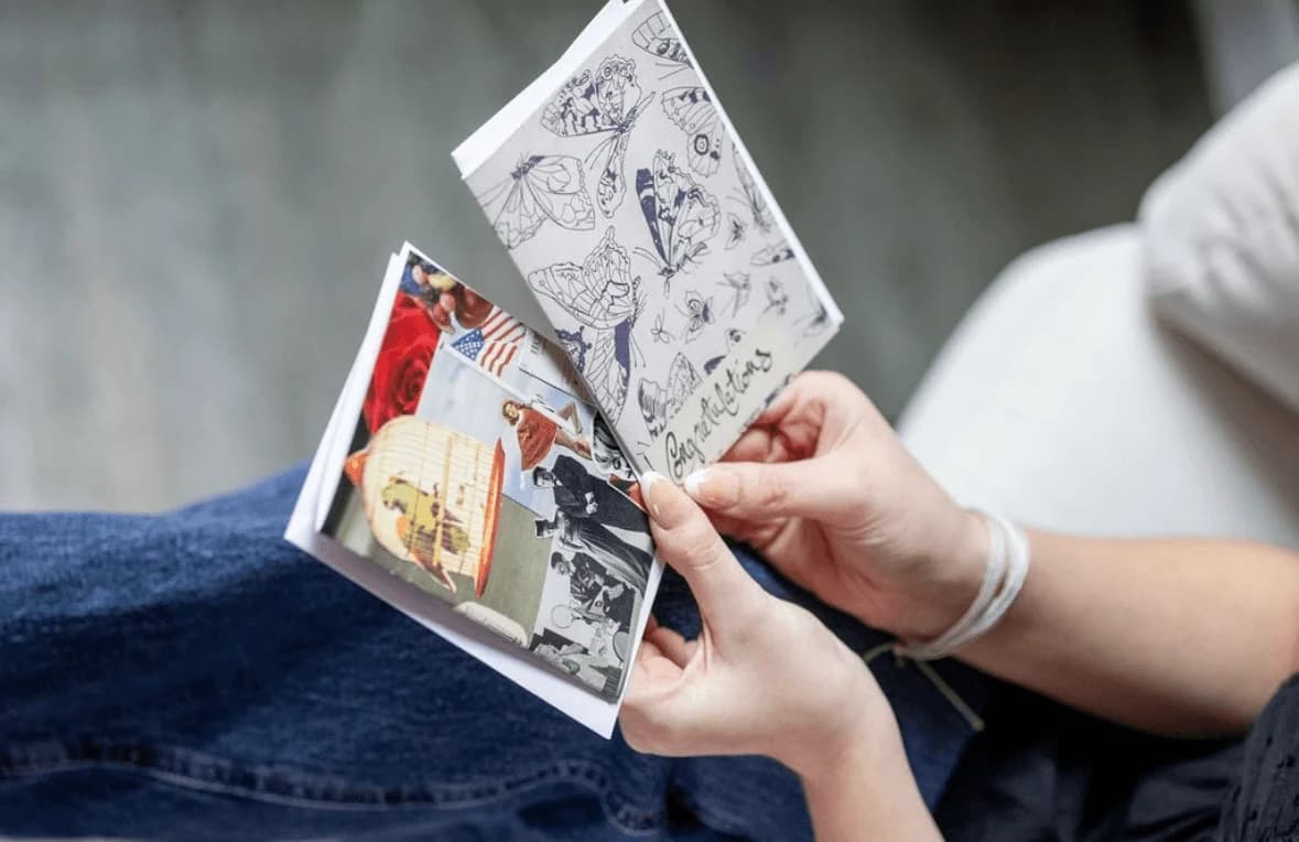 Claire holding a handmade card close to the camera